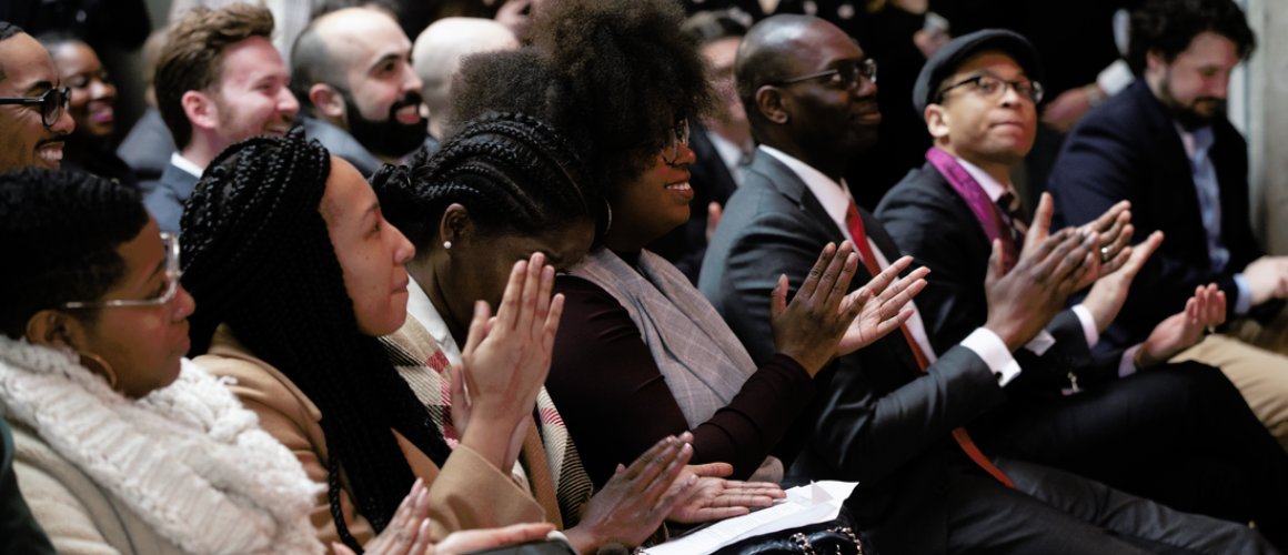 Participants at the Forbes Under 30 event applauding. 