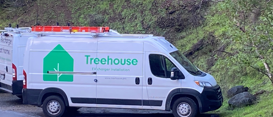 A photo of a van with the treehouse logo on the side. 