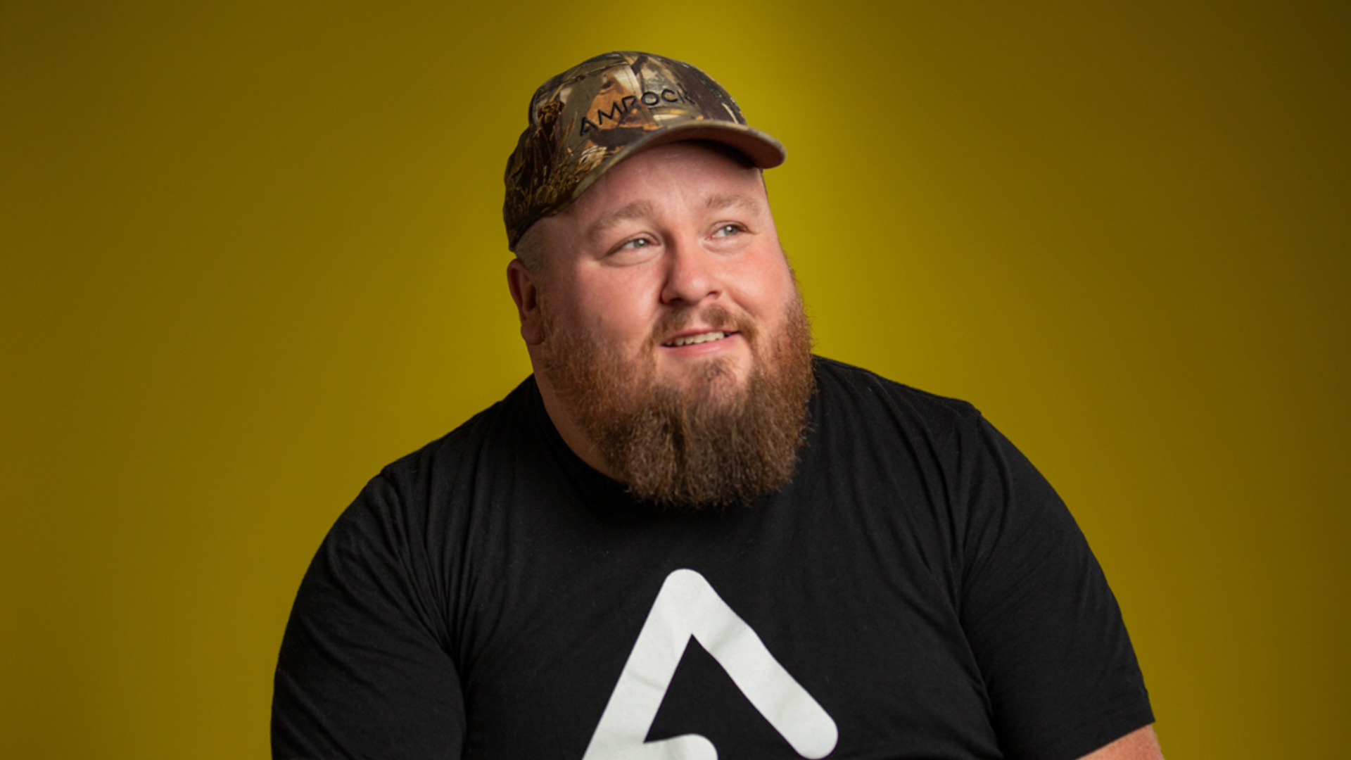 Photo of Ricky Crandell making an impact in front of a yellow background.