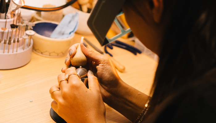 A photo of Halie working on jewelry 