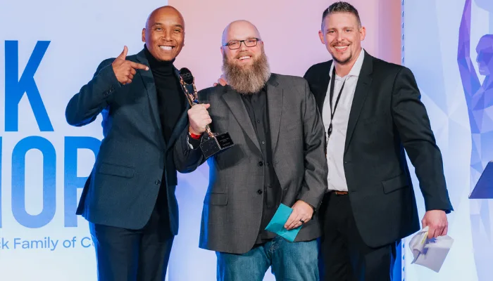 A photo of Evan at the ROCK Honors ceremony with two other team members.